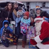Santa posing with children and families during last year's holiday toy drive
