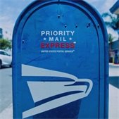 photo of blue outdoor us postal service mail drop box on street