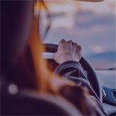 back seat view of woman driving car