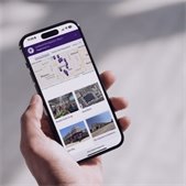 photo of hand holding smart phone with screen showing the Lombard developments page