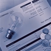 Utility bill with a light bulb and coins, representing energy assistance costs