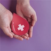set of hands holding a blood drop graphic with white cross in center with light purple background