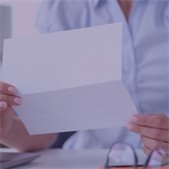 photo of person opening mail at home with glasses on table