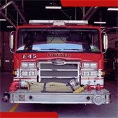 photo of front of red fire department engine inside station garage