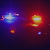 photo of police lights flashing in dark background or night