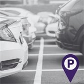 close up black and white photo of cars parked in parking lot with purple location icon
