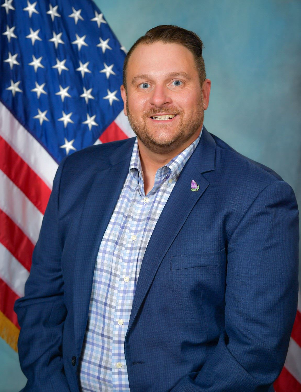 Headshot of Trustee Brian LaVaque with US flag in background