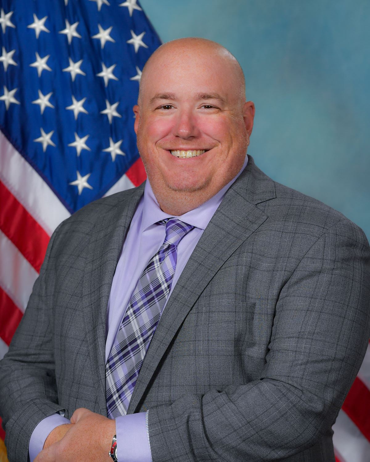 Headshot of Village President Anthony Puccio with US flag in background